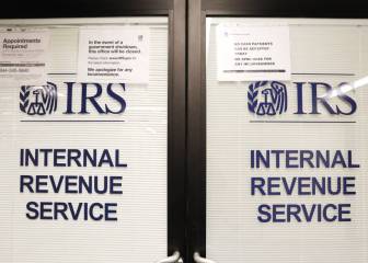 How can I talk to a real person when phoning the IRS helpline?