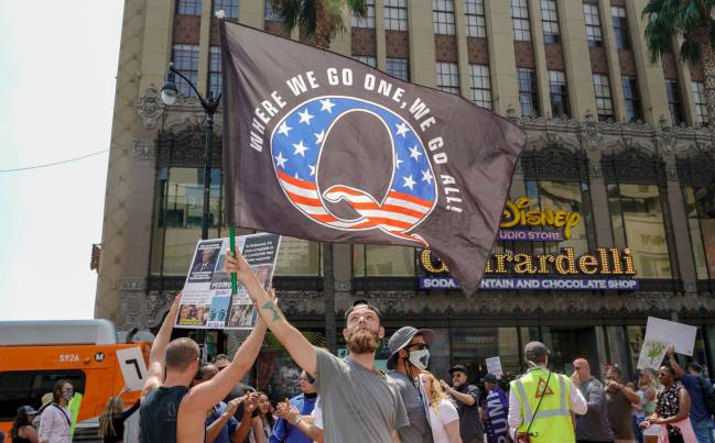 Conspiracy theorist QAnon demonstrators protest their belief in child trafficking on Hollywood Boulevard in Los Angeles, California.