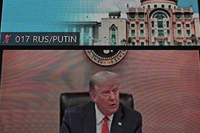 US President Donald Trump is pictured below the empty space where Russian President Vladimir Putin was set to join