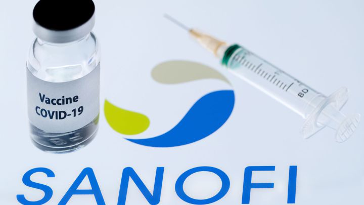This file photo taken on November 23, 2020 shows a bottle reading "Vaccine Covid-19" next to French biopharmaceutical company Sanofi logo. - France's Sanofi and Britain's GSK said on December 11, 2020 their Covid-19 vaccines will not be ready until the end of 2021, after interim results showed a low immune response in older adults. (Photo by JOEL SAGET / AFP)