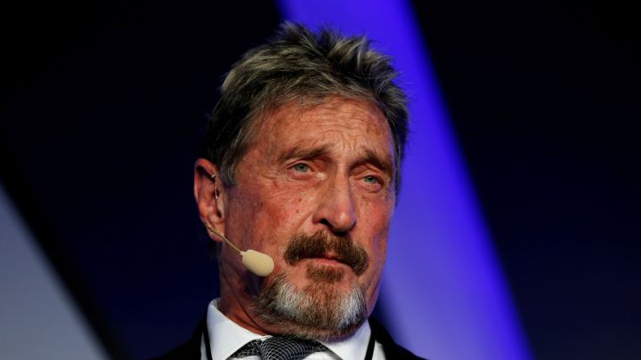 Why was John McAfee in exile and what was he being extradited for?