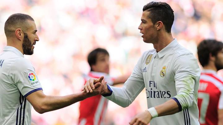 Real Madrid's French forward Karim Benzema (C) is congratulated by teammates Portuguese forward Cristiano Ronaldo (R) and defender Nacho Fernandez (L) after scoring their team's first goal during the Spanish league football match Athletic Club Bilbao vs Real Madrid CF at the San Mames stadium in Bilbao on March 18, 2017.