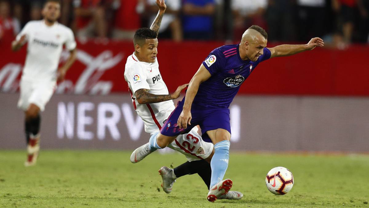 Stanislava Lobotka se lleva el balón ante la presencia de Arana, jugador del Sevilla.
