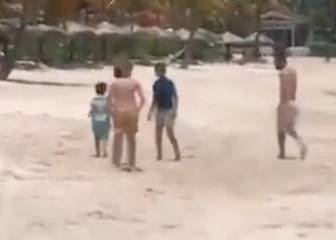 Lucky kids: Messi joins in beach football on holiday