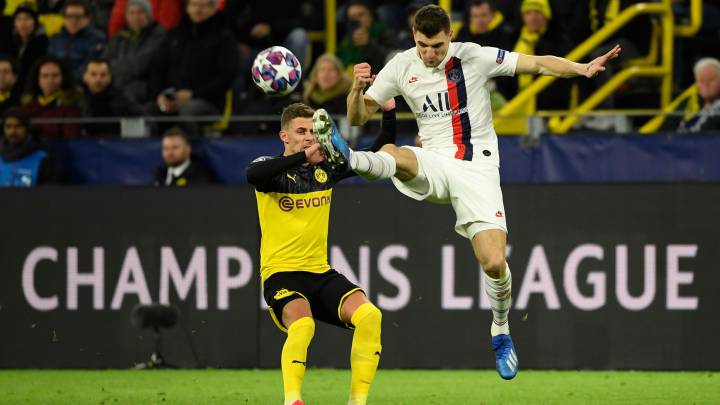 Paris Saint-Germain's Belgian defender Thomas Meunier (R) and Dortmund's Belgian forward Thorgan Hazard vie for the ball during the UEFA Champions League Last 16, first-leg football match BVB Borussia Dortmund v Paris Saint-Germain (PSG) in Dortmund, western Germany, on February 18, 2020. (Photo by Ina Fassbender / AFP)