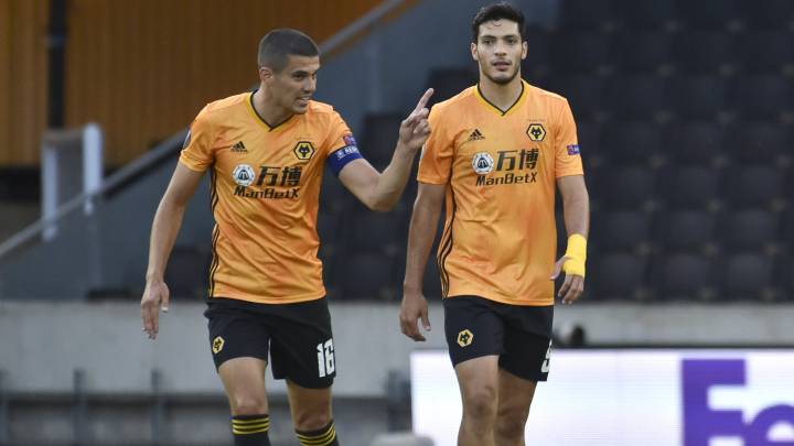 Wolverhampton Wanderers' Raul Jimenez, right, talks with his captain Conor Coady after scoring his team's first goal from the penalty spot during the Europa League round of 16 second leg soccer match between Wolves and Olympiakos at Molineux Stadium in Wolverhampton, England, Thursday, Aug. 6, 2020. (AP Photo/Rui Vieira)