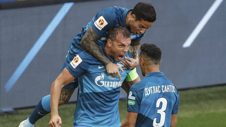 Zenit's Artem Dzyuba, center, celebrates with teammates after scoring the opening goal during the Russian Super Cup final soccer match between Zenit St. Petersburg and Locomotiv Moscow at CSKA Arena in Moscow, Russia, Friday, Aug. 7, 2020. (Alexander Safonov, Championat.com via AP)