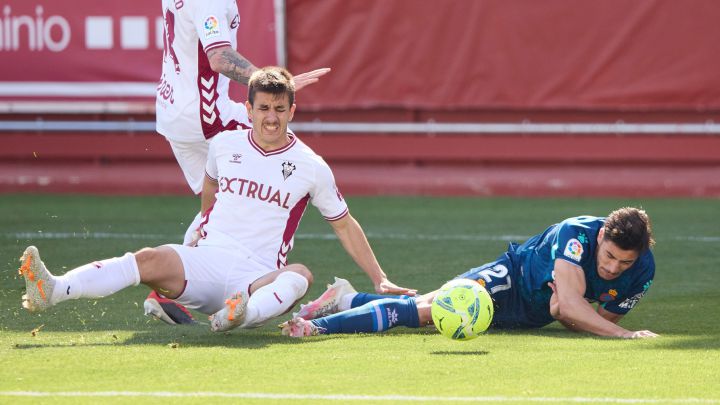 Oscar Gil of RCD Espanyol is fouled by Manuel Fuster of Albacete BP