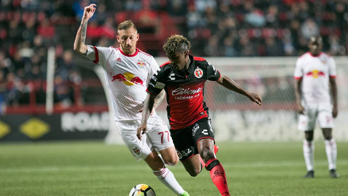 Miler Bolaños conduce el balón ante el acecho de un jugador de NY Red Bulls