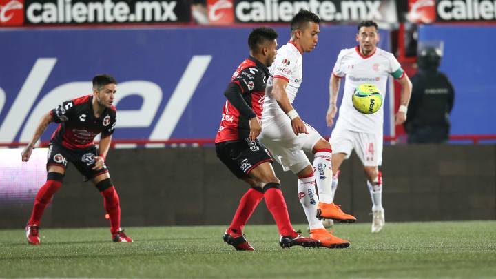 Fernando Uribe disputa un balón con un jugador de Xolos.