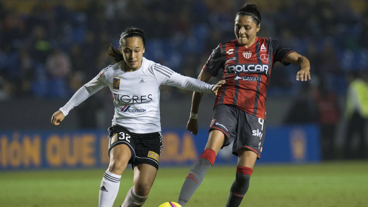 Jugadoras de fútbol disputando el esférico