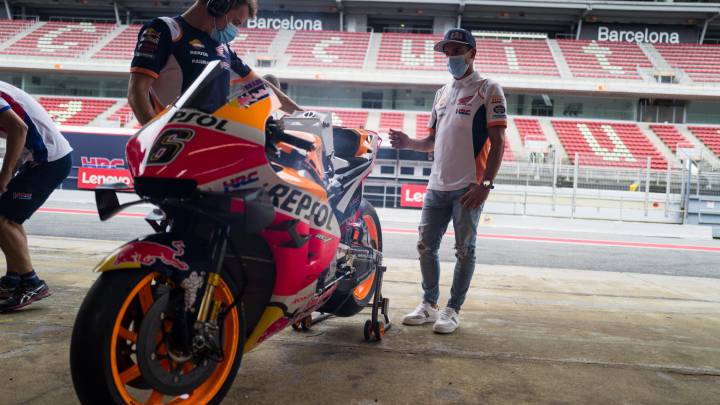 Márquez observa la Honda de Bradl durante su visita a Montmeló.