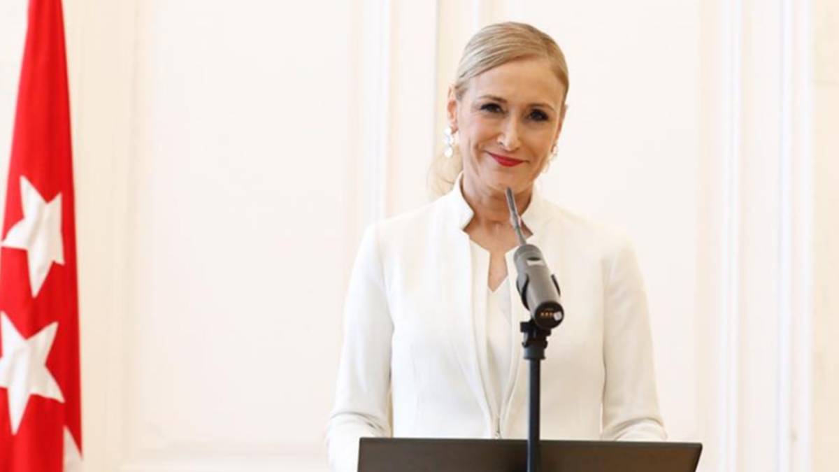 Cristina Cifuentes sonriente y vestida de blanco durante la rueda de prensa que concedió en abril de 2018 para dimitir como presidenta de la Comunidad de Madrid. Foto Facebook @cristinacifuentes