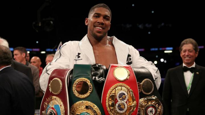 Anthony Joshua muestra sus cinturones