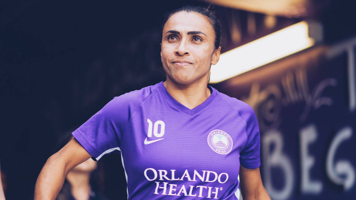 Jugadora DE FÚTBOL VESTIDA CON UNIFORME MORADO