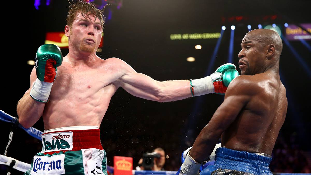 Canelo Alvarez throws a left at Floyd Mayweather Jr. during their WBC/WBA 154-pound title fight at the MGM Grand Garden Arena