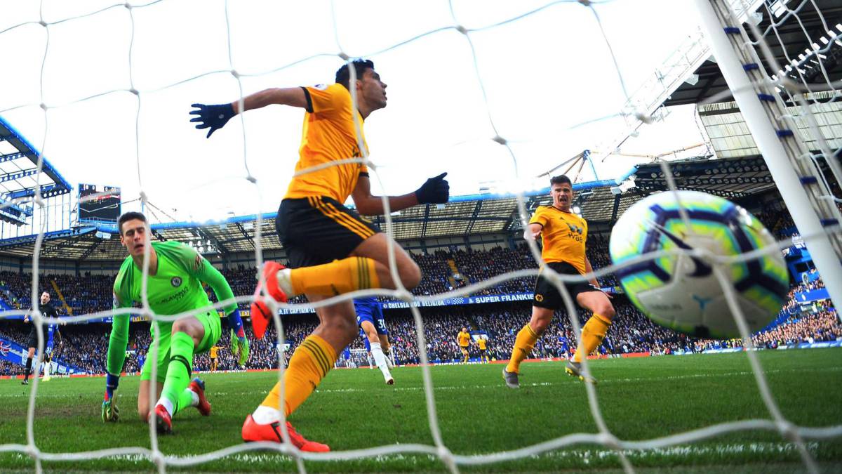 Mexican striker Raul Jimenez scores the opening goal past Chelsea's Spanish goalkeeper Kepa Arrizabalaga