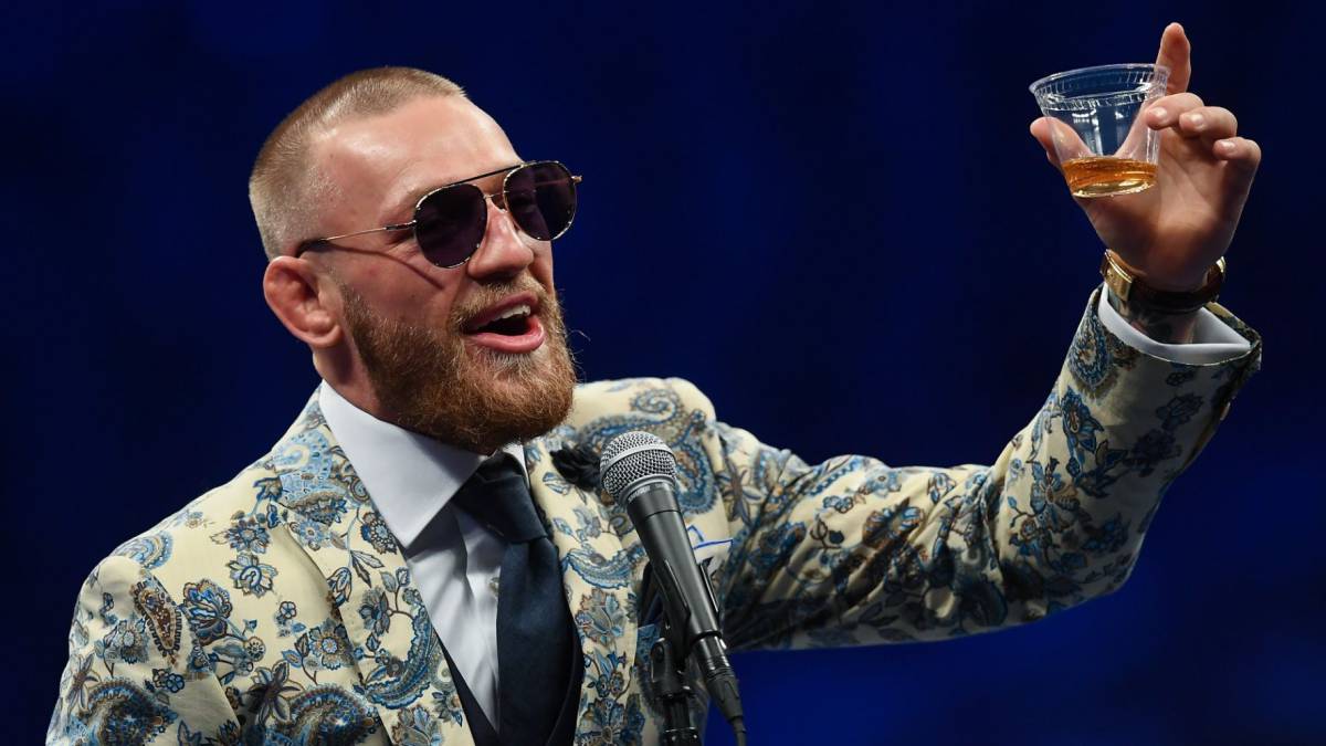 Irish UFC fighter Conor McGregor cheers during a presentation