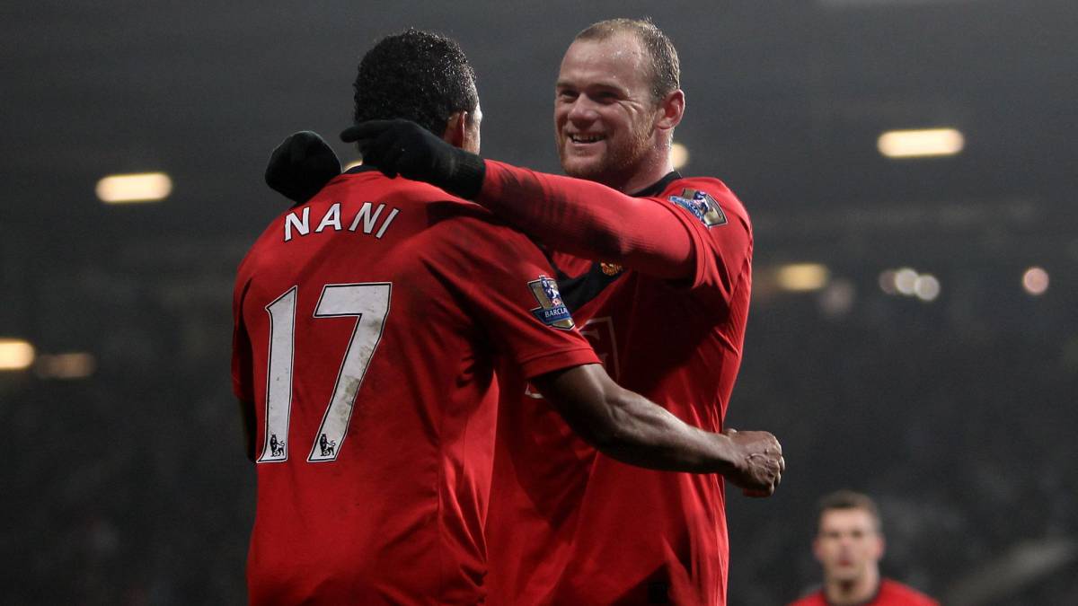 Wayne Rooney of Manchester United celebrates scoring his hat-trick with Nani