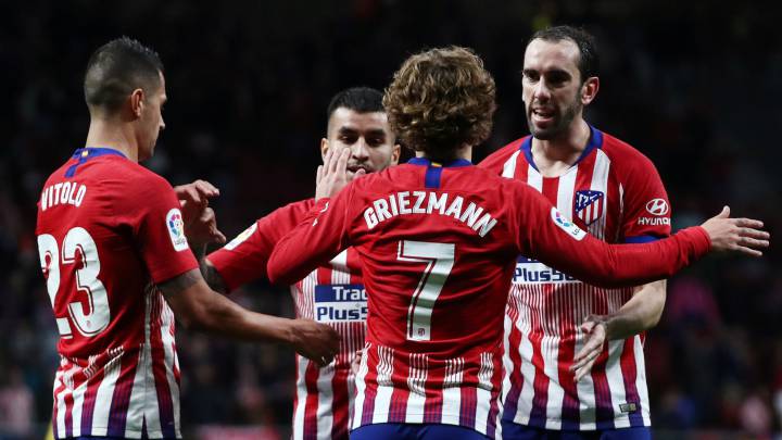 Atletico Madrid's Antoine Griezmann celebrates scoring their second goal with Diego Godin and team mates