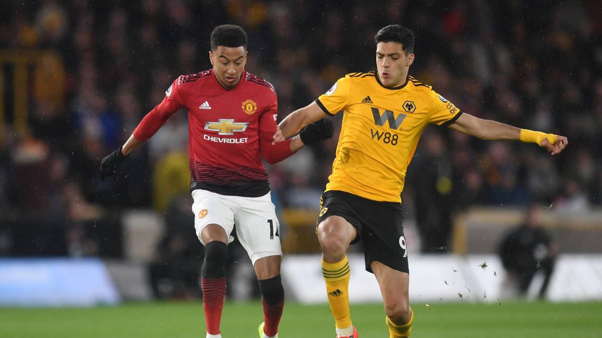 Jesse Lingard of Manchester United is challenged by Raul Jimenez of Wolverhampton Wanderers during the Premier League match