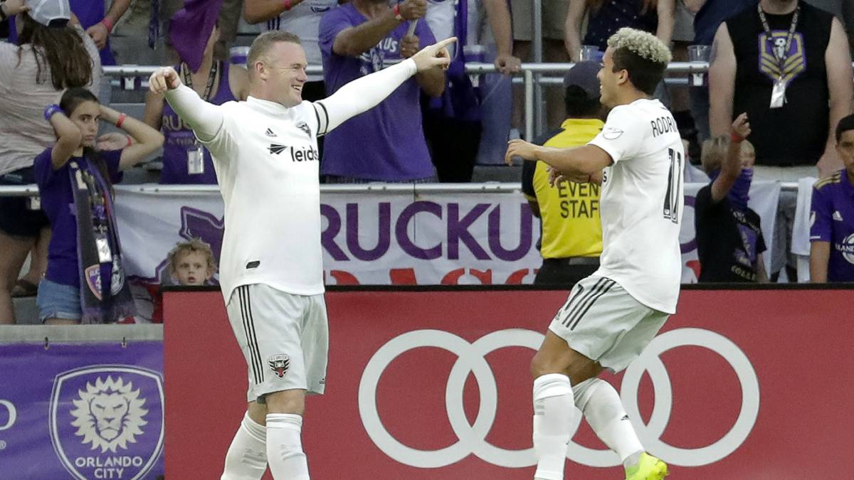 D.C. United's Wayne Rooney, left, celebrates his goal against Orlando City with teammate Lucas Rodriguez