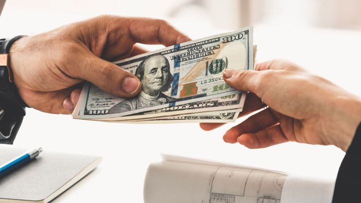 Hombre entregando dinero a otra persona