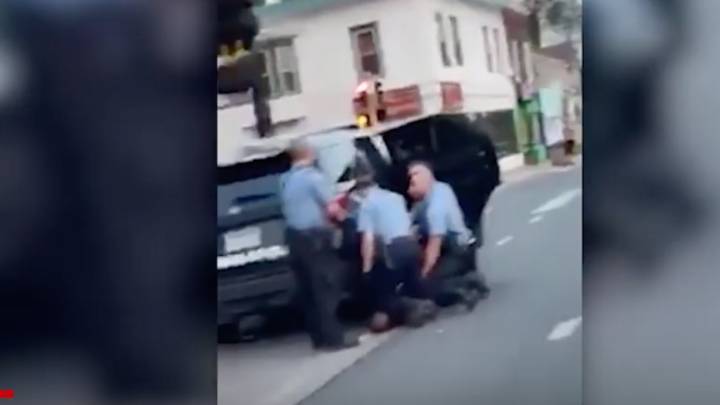 New video shows 3 policemen kneeling on George Floyd