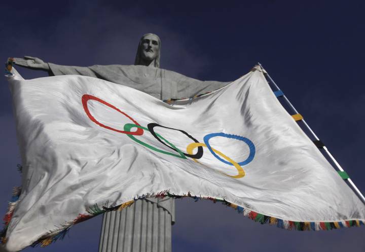 The Olympic flag, in front of the famous statue of Christ the Redeemer in Rio de Janiero.