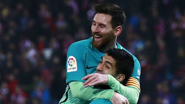 Lionel Messi (L) of FC Barcelona celebrates scoring their second goal with teammates Luis Suarez (R) a during the Copa del Rey semi-final first leg match between Club Atletico de Madrid and Barcelona