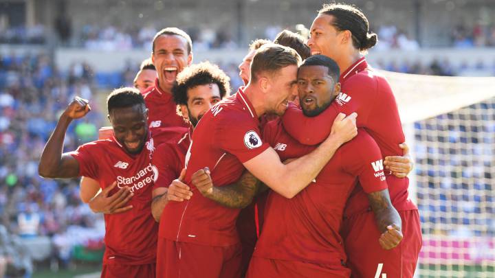 Georginio Wijnaldum of Liverpool is surrounded by team mates after scoring during the Premier League match between Cardiff City and Liverpool FC 