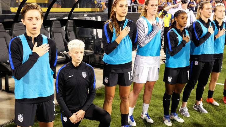 Megan Rapinoe protests against Donald Trump administration by kneeling during the national anthem