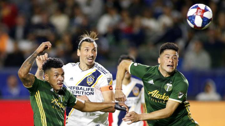 Jeremy Ebobisse of Portland Timbers, Zlatan Ibrahimovic of Los Angeles Galaxy, and Jorge Moreira of Portland Timbers react after fighting over a header during the second half at Dignity Health Sports Park on March 31, 2019 in Carson, California.