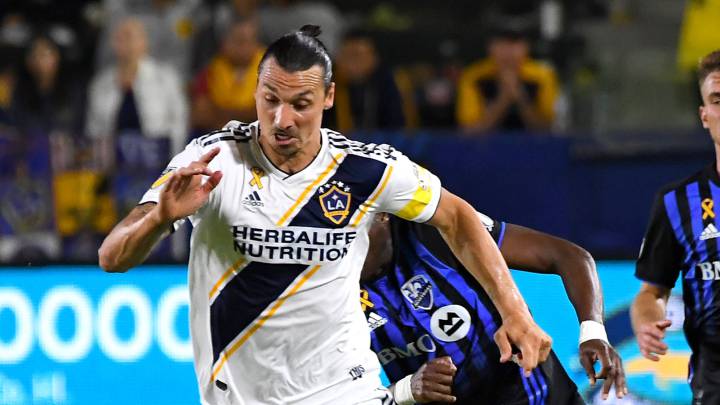; Los Angeles Galaxy forward Zlatan Ibrahimovic (9) steals the ball from Montreal Impact defender Rod Fanni (16) and takes it down field in the second half of the game at StubHub Center. 