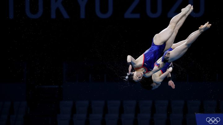 How fast do Olympic divers hit the water and how high do they dive from?