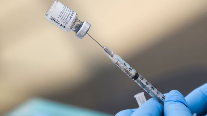 Why might vaccinated Americans need a booster shot?