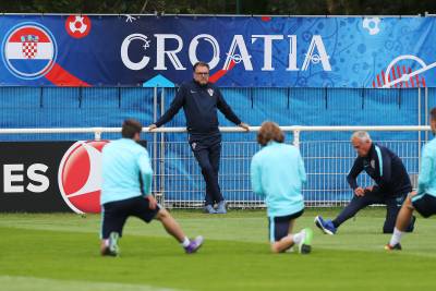 Cacic observa a sus jugadores entrenar.