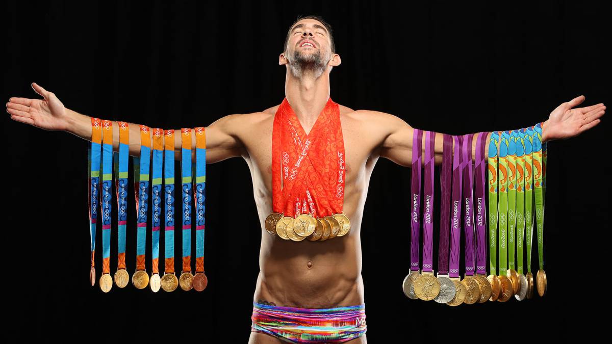 Swimmer Michael Phelps poses with all 28 Olympic medals