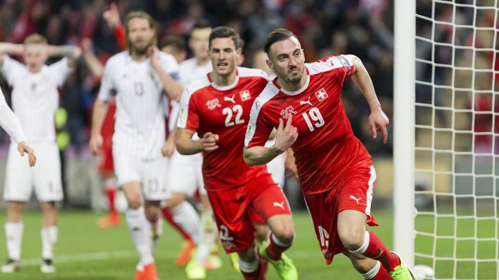 Swiss forward Josip Drmic (R) celebrates scoring the opening goal during the 2018 Fifa World Cup Russia group B qualification soccer match between Switzerland and Latvia, at the stade de Geneve stadium, in Geneva, Switzerland, 25 March 2017.
