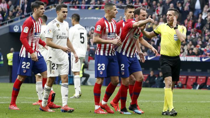 Los jugadores del Atlético reclaman al árbitro un penalti sobre Morata en el partido ante el Real Madrid.