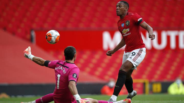 MANCHESTER, ENGLAND - JULY 13: Alex McCarthy of Southampton saves a shot from Anthony Martial of Manchester United during the Premier League match between Manchester United and Southampton FC at Old Trafford on July 13, 2020 in Manchester, England. Football Stadiums around Europe remain empty due to the Coronavirus Pandemic as Government social distancing laws prohibit fans inside venues resulting in all fixtures being played behind closed doors. (Photo by Clive Brunskill/Getty Images)
