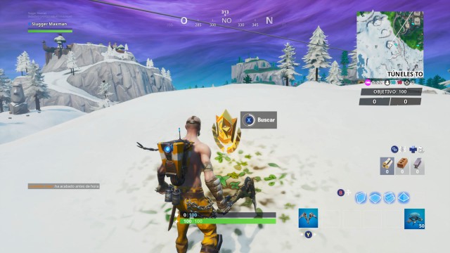 fortnite battle royale temporada 10 temporada x desafios taquillazo desafio busca entre una videocamara de sotano una cabeza de piedra nevada y un gran y llamativo trailer de oro