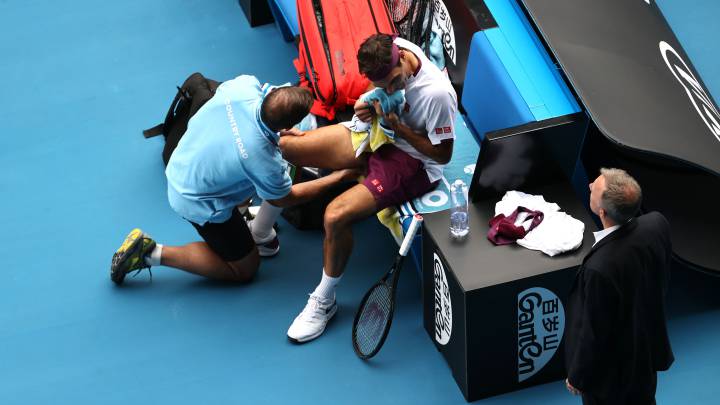 Roger Federer recibe asistencia médica durante su partido ante Tennys Sandgren en el Open de Australia 2020.