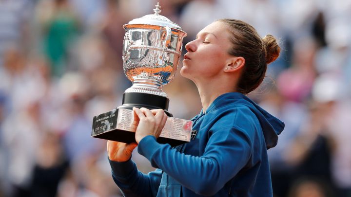 Simona Halep kisses the 2018 Roland Garros champion trophy.