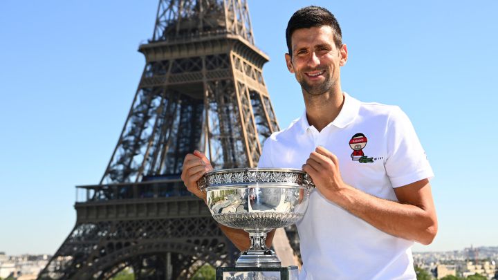 Novak Djokovic poses with the 2021 Roland Garros trophy in front of the Eiffel Tower in Paris.