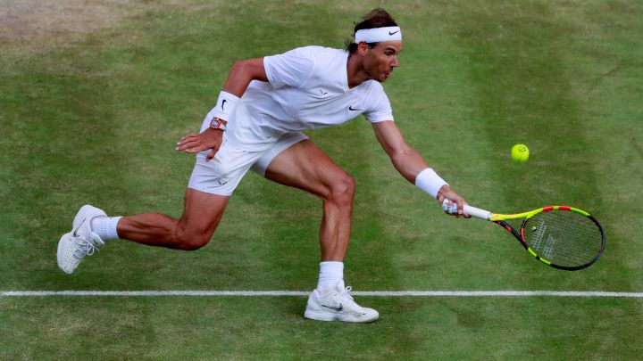 Rafa Nadal returns a ball during his match against Roger Federer in the 2019 Wimbledon semi-finals.