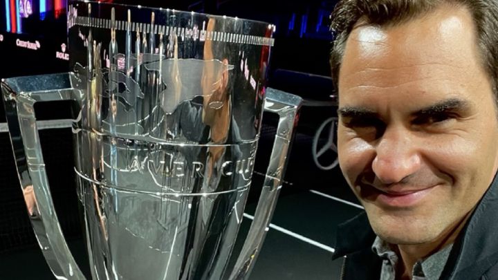 Roger Federer poses next to the champion trophy before the start of the Laver Cup in Boston.