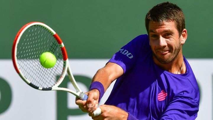 Cameron Norrie of Great Britain hits a backhand return to Diego Schwartzman of Argentina in their quarterfinal match at the Indian Wells tennis tournament on October 14, 2021 in Indian Wells, California.  (Photo by Frederic J. BROWN / AFP)