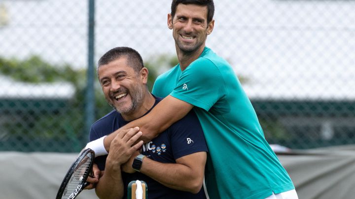 LONDON, ENGLAND - JUNE 30: Novak Djokovic of Serbia hugs his physiotherapist Ulises Badio on the Aorangi Practice Courts during Day Three of The Championships - Wimbledon 2021 at All England Lawn Tennis and Croquet Club on June 30, 2021 in London, England. (Photo by AELTC - Pool/Getty Images)
