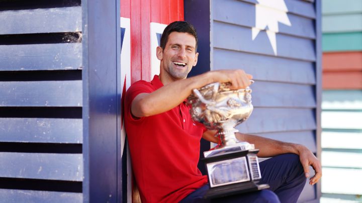 Novak Djokovic poses with the 2021 Australian Open champion trophy.